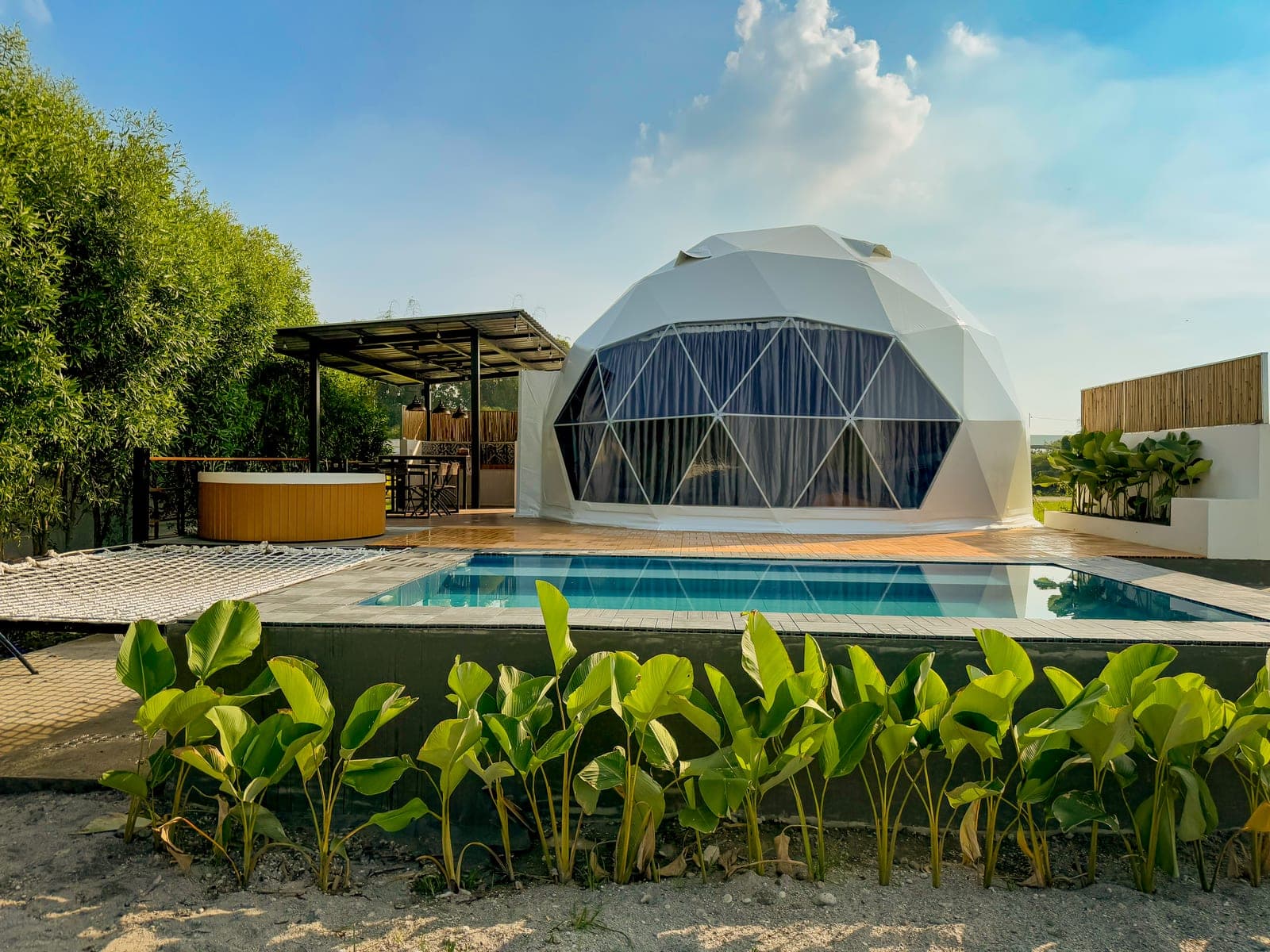 A private swimming pool directly outside a glamping dome